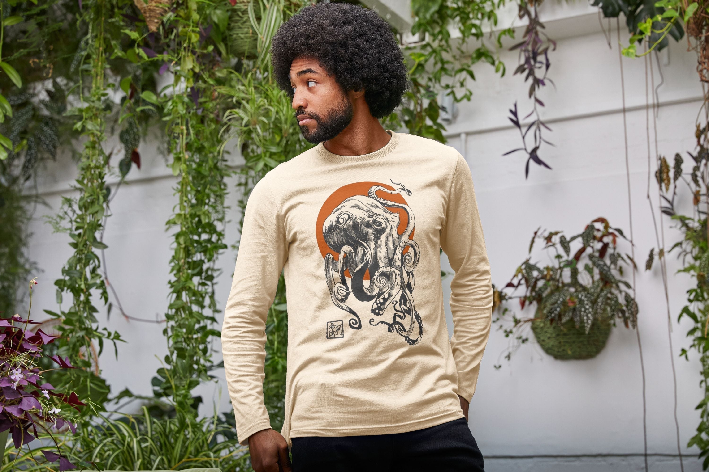 A guy wears a cool what the kraken long sleeve tee