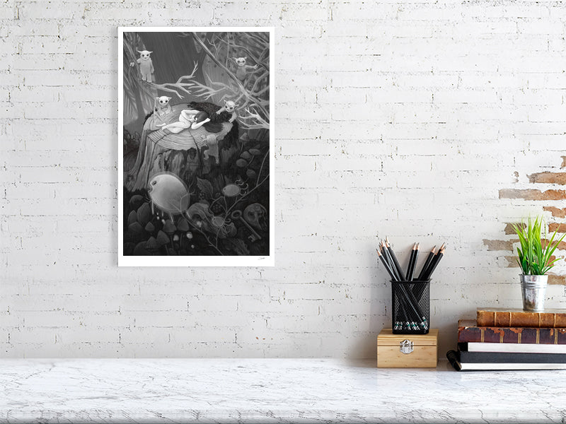 Framed black and white artwork on a white brick wall above a desk with stationery items.